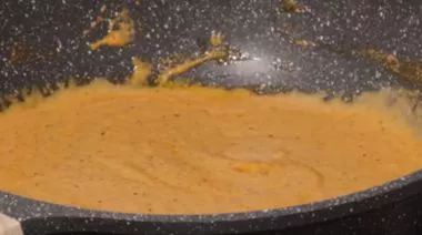 Shahi paneer in rich creamy gravy garnished with cream